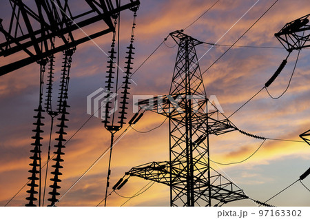 Electricity pylon (high voltage power line), black contour,  against the background of a romantic evening sky 97163302