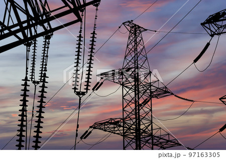 Electricity pylon (high voltage power line), black contour,  against the background of a romantic evening sky 97163305