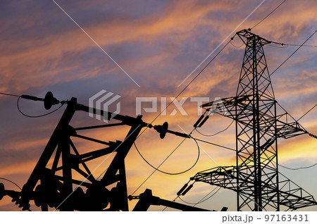 Electricity pylon (high voltage power line), black contour,  against the background of a romantic evening sky 97163431