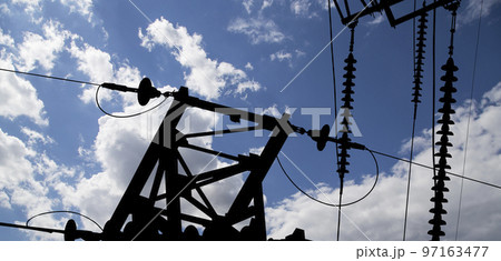 Electricity pylon (high voltage power line), black contour,  on the background of the cloudy sky 97163477