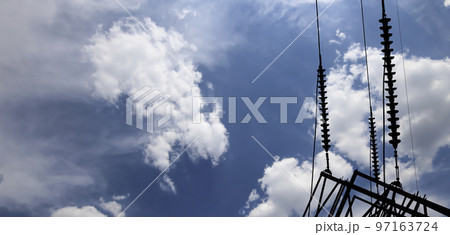 Electricity pylon (high voltage power line), black contour,  on the background of the cloudy sky 97163724
