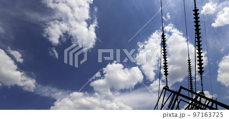 Electricity pylon (high voltage power line), black contour,  on the background of the cloudy sky 97163725