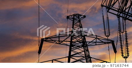 Electricity pylon (high voltage power line), black contour,  against the background of a romantic evening sky 97163744