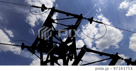 Electricity pylon (high voltage power line), black contour,  on the background of the cloudy sky 97163753