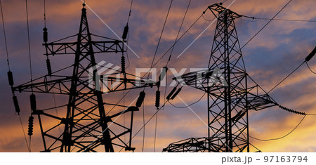 Electricity pylon (high voltage power line), black contour,  against the background of a romantic evening sky 97163794