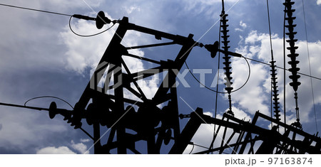 Electricity pylon (high voltage power line), black contour,  on the background of the cloudy sky 97163874