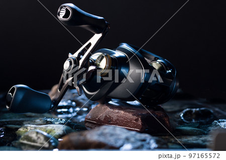 Fishing reel for twitching fishing. Fishing multiplier reel. Fishing reel with two handles. Fishing and stones. Fishing reel for twitching fishing. Fishing multiplier reel. Fishing reel with two handles. Fishing and stones. 97165572