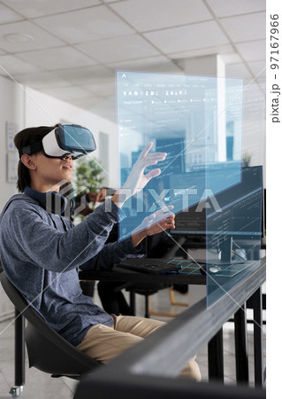 System engineer writing html code and using holographic program with augmented reality, displaying artificial intelligence algorithm. App developer coding database and checking ar hologram. System engineer writing html code and using holographic program with augmented reality, displaying artificial intelligence algorithm. App developer coding database and checking ar hologram. 97167966