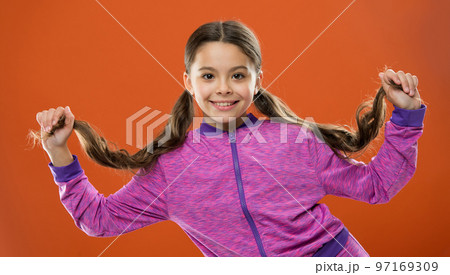 Small girl child. Hairdresser for kids. Happy little girl with long hair. childrens day. Portrait of happy little child. Kid fashion sportswear. childhood happiness. Family. Capturing bright moments 97169309