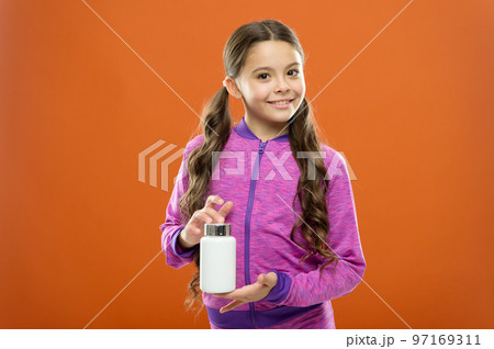 Girl long hair hold medicines bottle. Vitamin concept. Need vitamin supplements. Child cute girl take some medicines. Treatment and medicine. Natural product. Take vitamin supplements. Health care 97169311