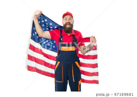 Guy worker uniform. Builder regular worker. Job relocation. Country of opportunities. National holiday. Worker celebrate independence day. Work visa USA. Man hold american flag. Repair and renovation 97169681