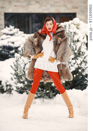 Attractive woman in wintertime outdoor. Lady with red lips. Fashion theme. Attractive woman in wintertime outdoor. Lady with red lips. Fashion theme. 97169960