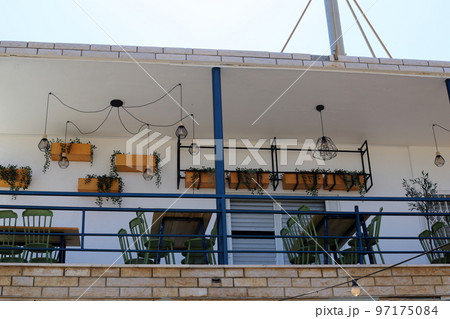 Balcony - a platform with railings protruding on the upper floors of the building. 97175084