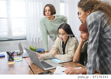 business team working at a table in a coworking center . 97176343