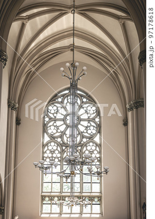 Bright interior of the church with stained-glass windows, view from below. 97178618