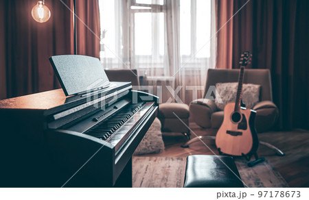 Electronic piano in the interior of the room on a blurred background. 97178673