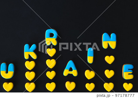 The word Ukraine on a black background, made with handmade gingerbread. The word Ukraine on a black background, made with handmade gingerbread. 97178777