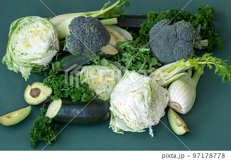 Fresh vegetables and greens on a green background. Fresh vegetables and greens on a green background. 97178778