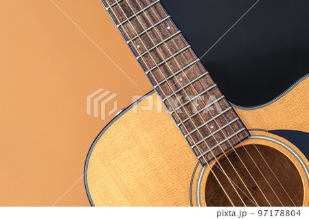 Acoustic guitar close-up on a colored background, flat lay. Acoustic guitar close-up on a colored background, flat lay. 97178804