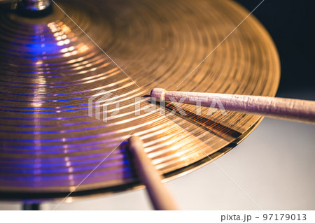 Close-up of drumsticks on a cymbal drum. 97179013