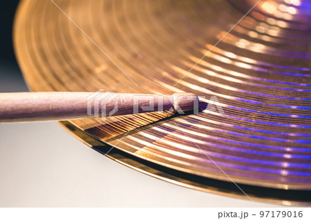 Close-up of drumsticks on a cymbal drum. Close-up of drumsticks on a cymbal drum. 97179016
