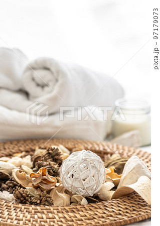 Spa composition with dried flowers, candles and towels. 97179073