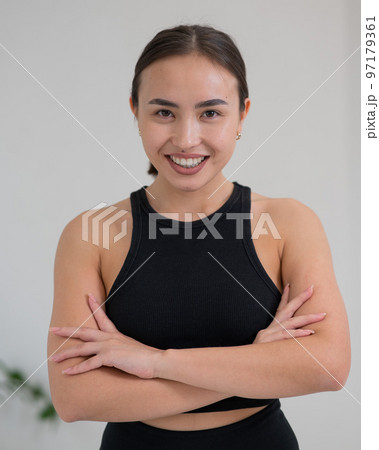 Portrait of a beautiful Asian woman with crossed arms on her chest. Portrait of a beautiful Asian woman with crossed arms on her chest. 97179361