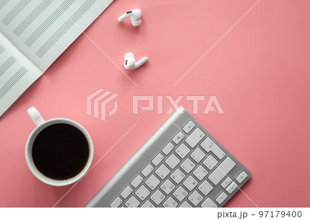 Notebook for writing notes and a cup of coffee on a pink background, flat lay. 97179400