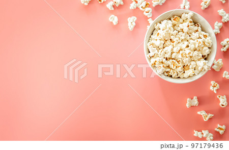 Popcorn plate on pink background, flat lay. Popcorn plate on pink background, flat lay. 97179436