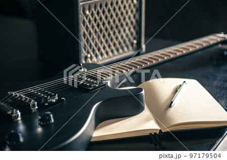 Close-up, electric guitar and notepad, concept of musical creativity. 97179504