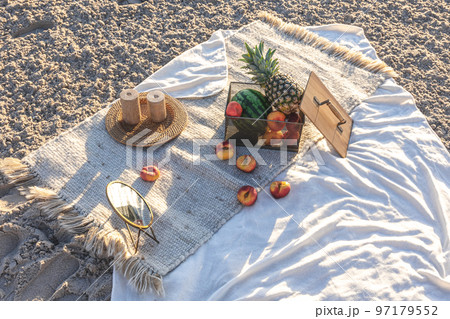 Plaid with fruits on the sandy seashore, picnic by the sea. Plaid with fruits on the sandy seashore, picnic by the sea. 97179552