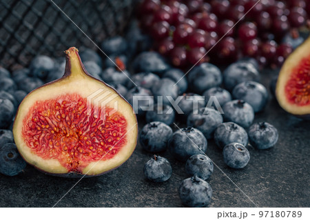 Close-up, figs in the cut among the berries. 97180789