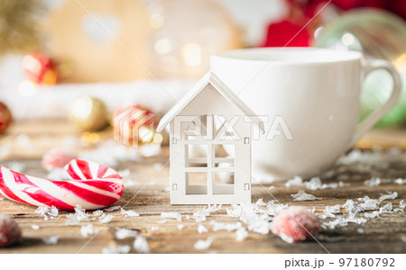 A little wooden house and Christmas decoration on wooden table. 97180792