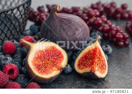 Close-up, figs in the cut among the berries. 97180821