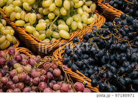 Baskets with different types of grapes on a supermarket showcase. Baskets with different types of grapes on a supermarket showcase. 97180971