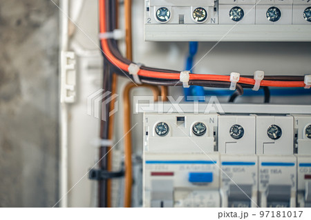 Close up circuit breakers and wire in control panel. 97181017