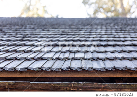 Close-up, the roof of a house made of wooden tiles. Close-up, the roof of a house made of wooden tiles. 97181022
