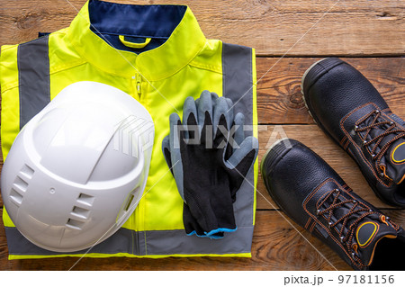 Builder uniform on wooden background, flat lay. 97181156
