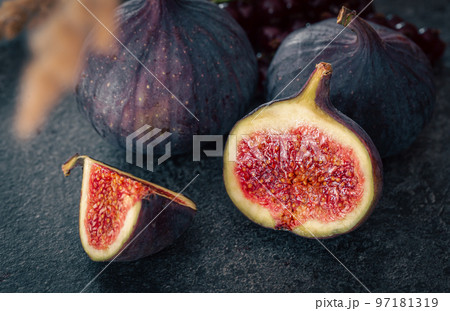 Close-up, fig fruit on a blurred dark background. Close-up, fig fruit on a blurred dark background. 97181319