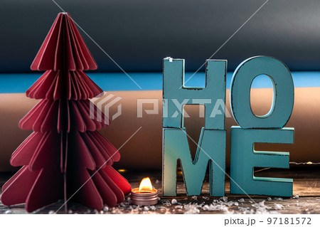 Cozy winter composition with decorative word home and paper christmas tree. 97181572