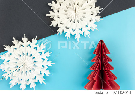 Christmas background with origami paper tree and snowflakes, flat lay. Christmas background with origami paper tree and snowflakes, flat lay. 97182011