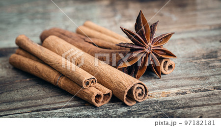 Star anise and cinnamon sticks close-up on a wooden background. 97182181