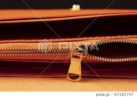Part of a leather wallet and purse on a black background. Part of a leather wallet and purse on a black background. 97182747