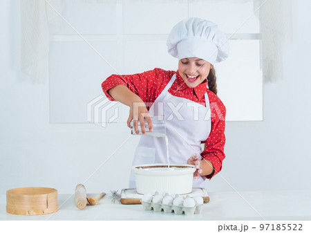 looking good. teen girl preparing dough. making cake by recipe. time to eat. happy child cooking in kitchen. bake cookies in kitchen. professional and skilled baker. kid in chef uniform and hat looking good. teen girl preparing dough. making cake by recipe. time to eat. happy child cooking in kitchen. bake cookies in kitchen. professional and skilled baker. kid in chef uniform and hat 97185522