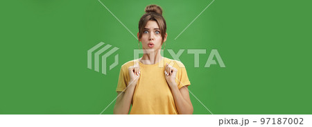 Studio shot of silly insecure and timid young wife feeling troubled and concerned, pressing hands to body folding lips and frowning looking scared and nervous facing troublesome situation, worry Studio shot of silly insecure and timid young wife feeling troubled and concerned, pressing hands to body folding lips and frowning looking scared and nervous facing troublesome situation, worry 97187002