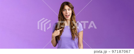 Accused frustrated upset shocked girl ambushed strange choice accusations pointing herself offended complaining frowning stand questioned displeased unfair decision purple background 97187067