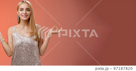 Calm relieved happy fabulous young blond woman in silver stylish luxury dress standing relaxed red background zen lotus pose reach nirvana smiling peaceful carefree meditating breathing practice Calm relieved happy fabulous young blond woman in silver stylish luxury dress standing relaxed red background zen lotus pose reach nirvana smiling peaceful carefree meditating breathing practice 97187820
