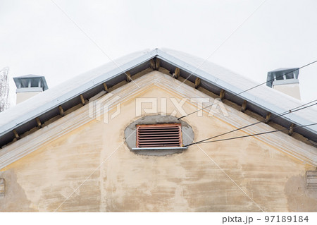 Two smoke, rectangular, exhaust pipes on the roof of an old house Two smoke, rectangular, exhaust pipes on the roof of an old house 97189184
