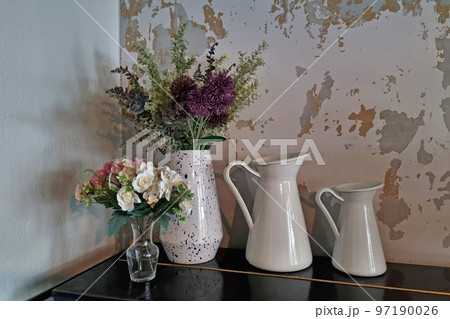 Jugs with flowers. Table decoration with flowers, holiday atmosphere. 97190026