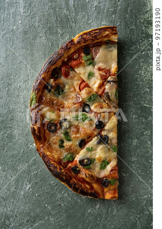 half a delicious homemade italian pizza on the table 97193190